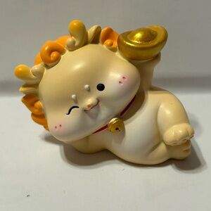 Cute Winking Figurine with Orange and Gold Accents